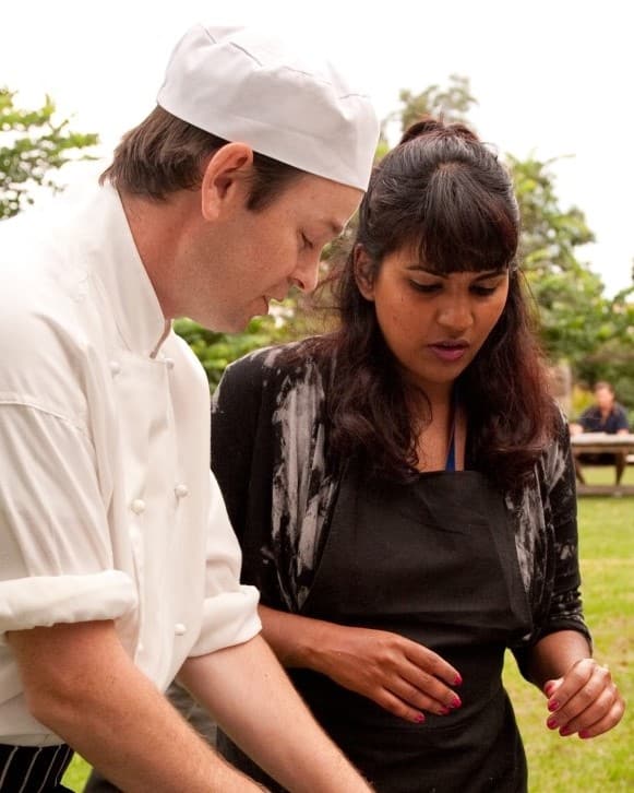 Chef explaining recipe to apprentice