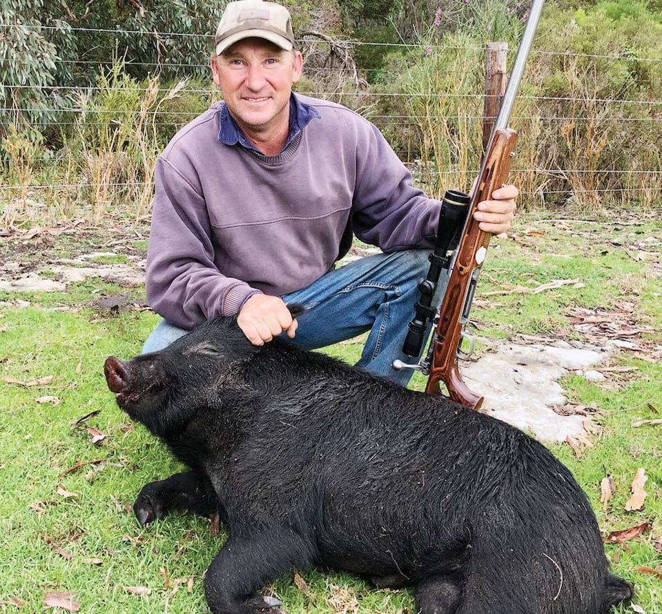 Farmer with feral pig