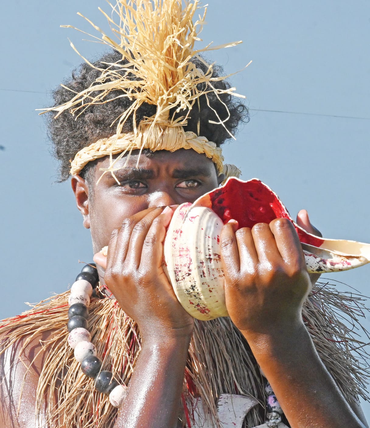 Blowing conch at Winds of Zenadth Festival
