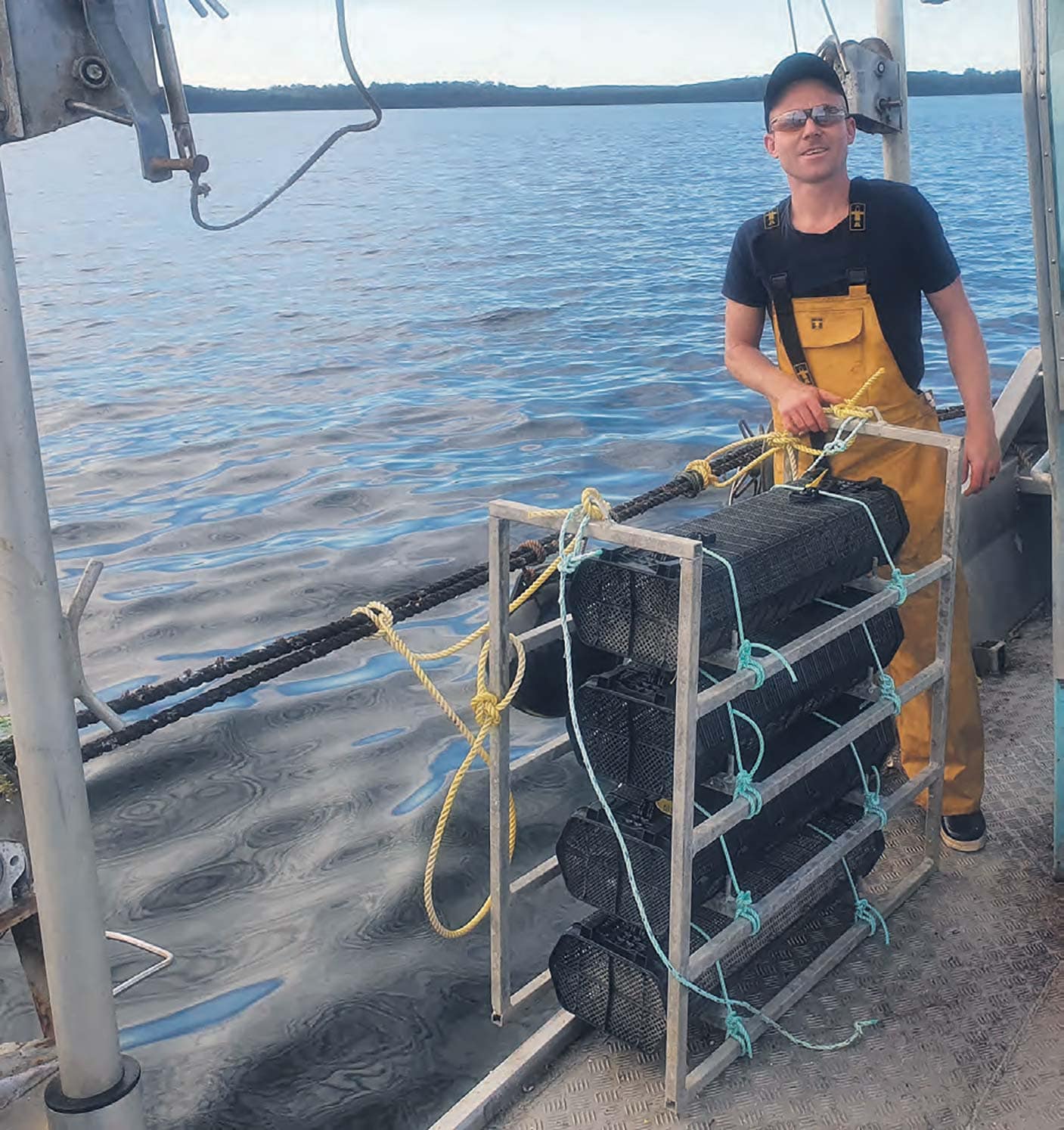 Zak Launay sets up oyster baskets in Wilson Inlet.