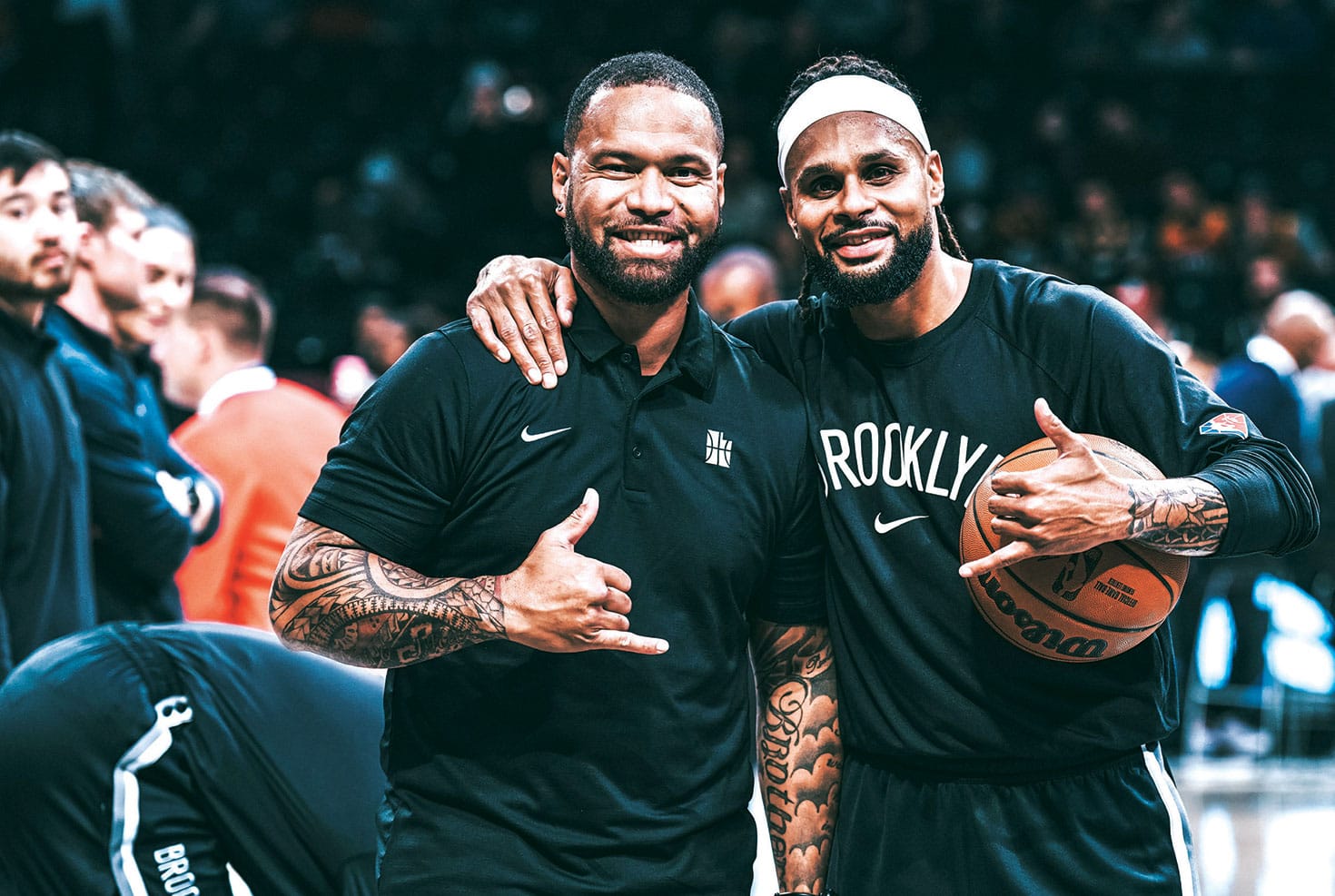 Junior Virantuleo and Patty Mills embrace before a game between Utah and Brooklyn. Picture: Matthew Adekponya