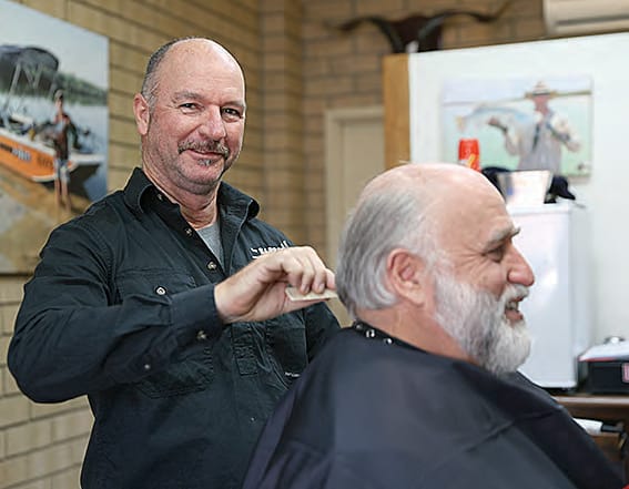 Corryong barber, Stuart Gallus, gives Ron Blyton a trim. Photo: Corryong Courier