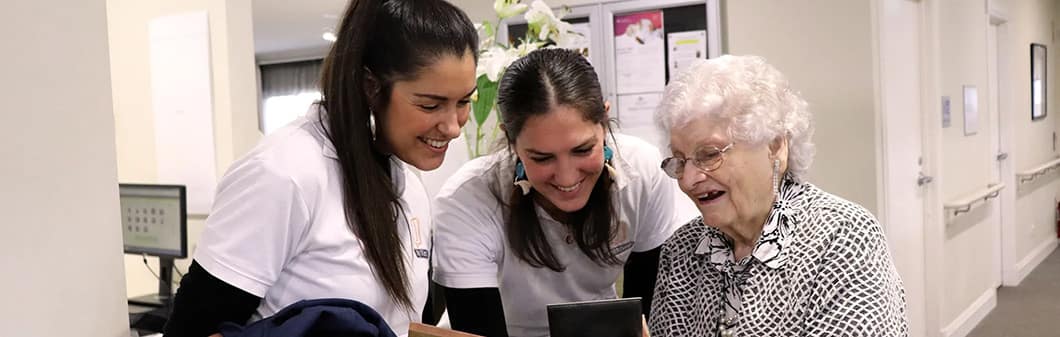 Young women looking at mobile with an older woman