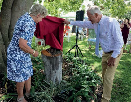 Beneath a huge Celtis tree on the grounds of Marinya, a grandson of Ruth Fairfax, Tim Fairfax AC and his wife Gina, unveiled a plaque commemorating the 100th anniversary of the foundation of the QCWA.